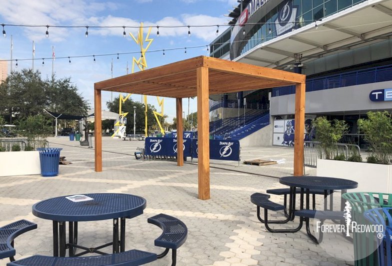 The Silverado Modern Pergola (options: 20' L, 20' W, Douglas-fir, No Electrical Wiring Trim, 7 1/4" x 7 1/4" Posts, No Privacy Panels, No Curtain Rods, 9.5' Post Height, Transparent Premium Sealant). Photo Courtesy of The Tampa Bay Lightning NHL Team. The Silverado Modern Pergola (options: 20' L, 20' W, Douglas-fir, No Electrical Wiring Trim, 7 1/4" x 7 1/4" Posts, No Privacy Panels, No Curtain Rods, 9.5' Post Height, Transparent Premium Sealant). Photo Courtesy of The Tampa Bay Lightning NHL Team.