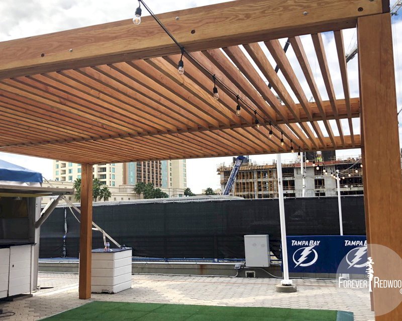 The Silverado Modern Pergola (options: 20' L, 20' W, Douglas-fir, No Electrical Wiring Trim, 7 1/4" x 7 1/4" Posts, No Privacy Panels, No Curtain Rods, 9.5' Post Height, Transparent Premium Sealant). Photo Courtesy of The Tampa Bay Lightning NHL Team. The Silverado Modern Pergola (options: 20' L, 20' W, Douglas-fir, No Electrical Wiring Trim, 7 1/4" x 7 1/4" Posts, No Privacy Panels, No Curtain Rods, 9.5' Post Height, Transparent Premium Sealant). Photo Courtesy of The Tampa Bay Lightning NHL Team.