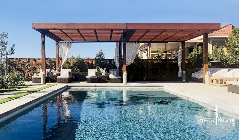 The Silverado Modern Pergola (Options: 30'-8" L, 16' W, California Redwood, No Electrical Wiring Trim, with 1 3/4" x 11 1/4" Roof Support Timbers and 7 1/4" x 7 1/4" Posts, Roof Rafter Spacing at 6", 6 Post Anchor Kit for Gale-Wind, No Privacy Panels, No Curtain Rods, 10' Post Height, Coffee-Stain Premium Sealant). Photo Courtesy of B. Aronson of Lincoln, CA. The Silverado Modern Pergola (Options: 30'-8" L, 16' W, California Redwood, No Electrical Wiring Trim, with 1 3/4" x 11 1/4" Roof Support Timbers and 7 1/4" x 7 1/4" Posts, Roof Rafter Spacing at 6", 6 Post Anchor Kit for Gale-Wind, No Privacy Panels, No Curtain Rods, 10' Post Height, Coffee-Stain Premium Sealant). Photo Courtesy of B. Aronson of Lincoln, CA.