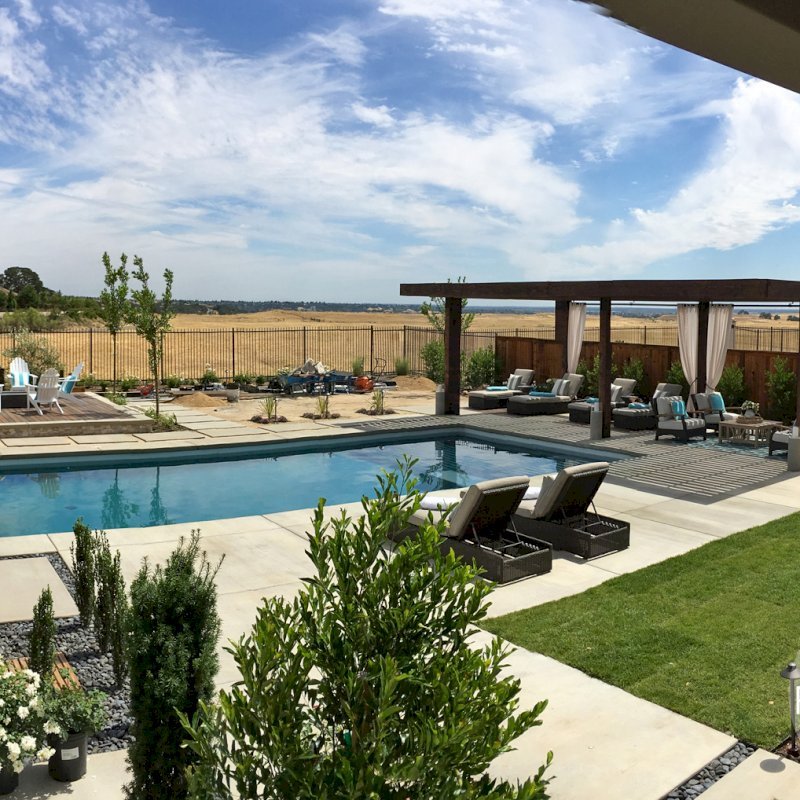 The Silverado Modern Pergola (Options: 30'-8" L, 16' W, California Redwood, No Electrical Wiring Trim, with 1 3/4" x 11 1/4" Roof Support Timbers and 7 1/4" x 7 1/4" Posts, Roof Rafter Spacing at 6", 6 Post Anchor Kit for Gale-Wind, No Privacy Panels, No Curtain Rods, 10' Post Height, Coffee-Stain Premium Sealant). Photo Courtesy of B. Aronson of Lincoln, CA. The Silverado Modern Pergola (Options: 30'-8" L, 16' W, California Redwood, No Electrical Wiring Trim, with 1 3/4" x 11 1/4" Roof Support Timbers and 7 1/4" x 7 1/4" Posts, Roof Rafter Spacing at 6", 6 Post Anchor Kit for Gale-Wind, No Privacy Panels, No Curtain Rods, 10' Post Height, Coffee-Stain Premium Sealant). Photo Courtesy of B. Aronson of Lincoln, CA.