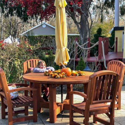 Sunset Patio Table (Options: 5' Diameter, With Chairs, Mature Redwood, 4 Luna Armchairs, No Cushions, Standard Tabletop, No Lazy Susan, 1 5/8" Umbrella Hole, Transparent Premium Sealant). Photo Courtesy of L. Scalise of Oakdale, NY.