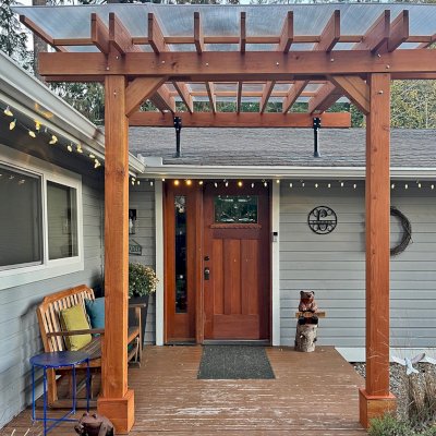 Custom Sunset Porch Pavilion (Options: 10' L x 9'-8" W, Douglas-fir, No Electrical Wiring Trim, 2-Post Anchor Kit for Concrete, with Roof Risers by Custom Request, 10' H Posts, No Post Decorative Trim, with Transparent Polycarbonate Roofing Panels Instead of the Standard Roof Boards, No Ceiling Fan Base, No Curtain Rods, Transparent Premium Sealant). Photo Courtesy of C. Cadieux of North Bend, WA.