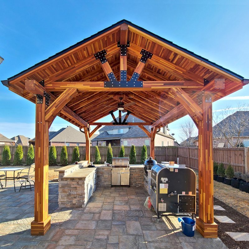 The Thick Timber Toledo Wood Pavilions (Options: 16' L x 14' W, Mosaic Eco-Wood, 4-Post Anchor Kit for High-Wind, Electrical Wiring Trim for 1 Post, 8 x 8 Supports and Posts, 8 x 8 Rafters, 1 Fan Base, Transparent Premium Sealant). Photo Courtesy of A. Shaver of Rogers, Arkansas. The Thick Timber Toledo Wood Pavilions (Options: 16' L x 14' W, Mosaic Eco-Wood, 4-Post Anchor Kit for High-Wind, Electrical Wiring Trim for 1 Post, 8 x 8 Supports and Posts, 8 x 8 Rafters, 1 Fan Base, Transparent Premium Sealant). Photo Courtesy of A. Shaver of Rogers, Arkansas.
