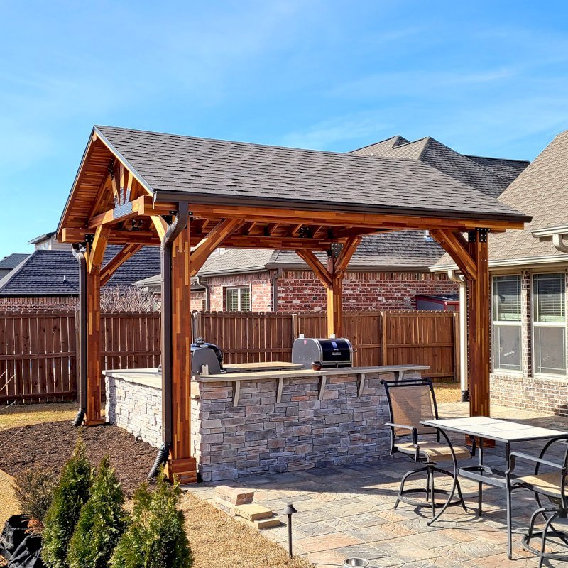 The Thick Timber Toledo Wood Pavilions (Options: 16' L x 14' W, Mosaic Eco-Wood, 4-Post Anchor Kit for High-Wind, Electrical Wiring Trim for 1 Post, 8 x 8 Supports and Posts, 8 x 8 Rafters, 1 Fan Base, Transparent Premium Sealant). Photo Courtesy of A. Shaver of Rogers, Arkansas. The Thick Timber Toledo Wood Pavilions (Options: 16' L x 14' W, Mosaic Eco-Wood, 4-Post Anchor Kit for High-Wind, Electrical Wiring Trim for 1 Post, 8 x 8 Supports and Posts, 8 x 8 Rafters, 1 Fan Base, Transparent Premium Sealant). Photo Courtesy of A. Shaver of Rogers, Arkansas.