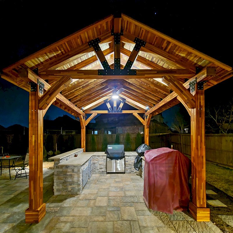 The Thick Timber Toledo Wood Pavilion (Options: 16' L x 14' W, Mosaic Eco-Wood, 4-Post Anchor Kit for High-Wind, Electrical Wiring Trim for 1 Post, 8 x 8 Supports and Posts, 8 x 8 Rafters, 1 Fan Base, Transparent Premium Sealant). Photo Courtesy of A. Shaver of Rogers, Arkansas. The Thick Timber Toledo Wood Pavilion (Options: 16' L x 14' W, Mosaic Eco-Wood, 4-Post Anchor Kit for High-Wind, Electrical Wiring Trim for 1 Post, 8 x 8 Supports and Posts, 8 x 8 Rafters, 1 Fan Base, Transparent Premium Sealant). Photo Courtesy of A. Shaver of Rogers, Arkansas.