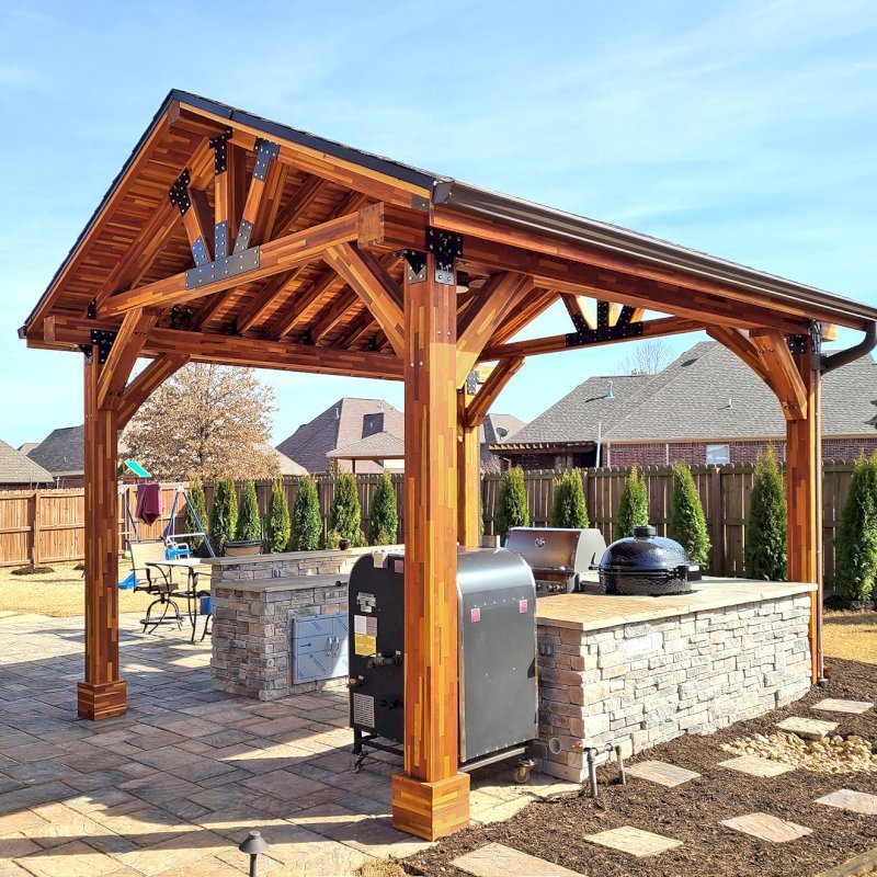 The Thick Timber Toledo Wood Pavilions (Options: 16' L x 14' W, Mosaic Eco-Wood, 4-Post Anchor Kit for High-Wind, Electrical Wiring Trim for 1 Post, 8 x 8 Supports and Posts, 8 x 8 Rafters, 1 Fan Base, Transparent Premium Sealant). Photo Courtesy of A. Shaver of Rogers, Arkansas. The Thick Timber Toledo Wood Pavilions (Options: 16' L x 14' W, Mosaic Eco-Wood, 4-Post Anchor Kit for High-Wind, Electrical Wiring Trim for 1 Post, 8 x 8 Supports and Posts, 8 x 8 Rafters, 1 Fan Base, Transparent Premium Sealant). Photo Courtesy of A. Shaver of Rogers, Arkansas.