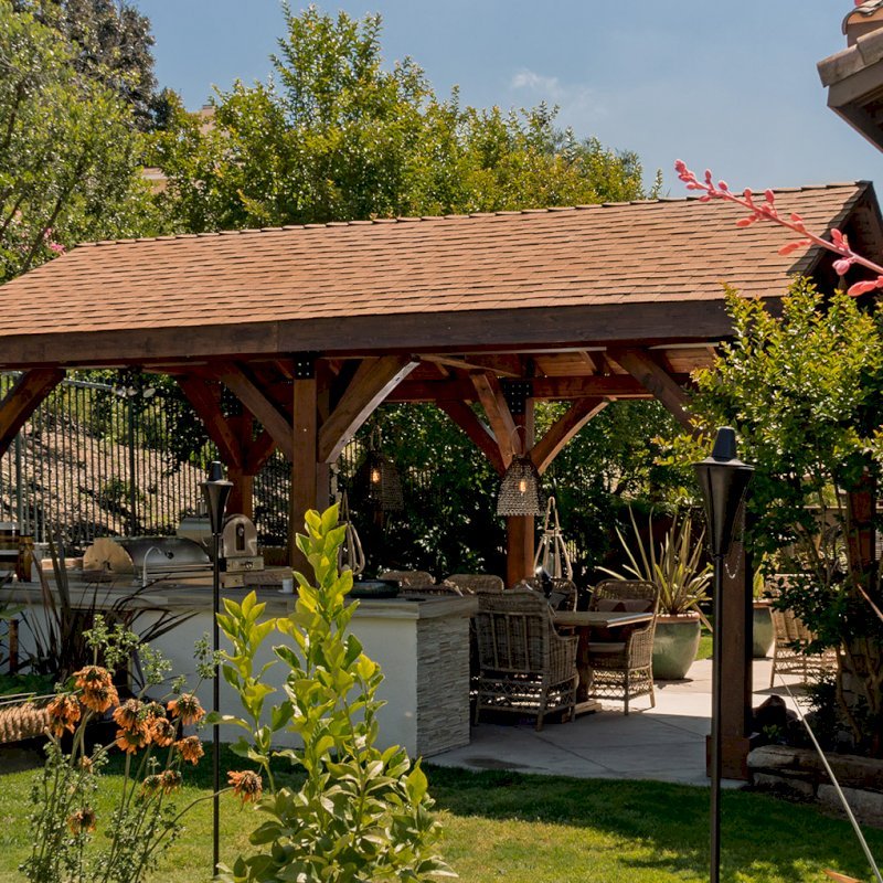 The Thick Timber Toledo Wood Pavilions (Options: 22' L x 14' W, Douglas-fir, 6-Post Anchor Kit for Gale-Wind, Electrical Wiring Trim for 1 Post, 8 x 8 Supports and Posts, 8 x 8 Rafters, No Fan Bases, Coffee-Stain Premium Sealant). Photo Courtesy of M. Moffitt Jackson of Foothills Ranch, California. The Thick Timber Toledo Wood Pavilions (Options: 22' L x 14' W, Douglas-fir, 6-Post Anchor Kit for Gale-Wind, Electrical Wiring Trim for 1 Post, 8 x 8 Supports and Posts, 8 x 8 Rafters, No Fan Bases, Coffee-Stain Premium Sealant). Photo Courtesy of M. Moffitt Jackson of Foothills Ranch, California.