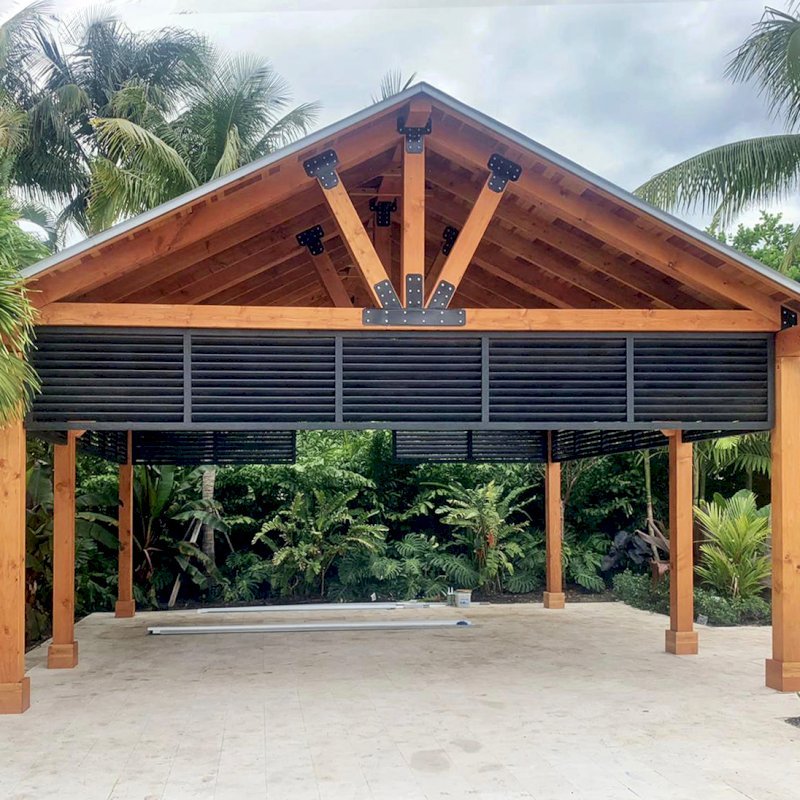 The Thick Timber Toledo Wood Pavilion (Options: 20' L x 20' W, California Redwood, 6-Post Anchor Kit for High-Wind, No Electrical Wiring Trim, 8 x 8 Supports and Posts, 8 x 8 Rafters, No Fan Base, With Custom Bahama Shutters, Transparent Premium Sealant). The Thick Timber Toledo Wood Pavilion (Options: 20' L x 20' W, California Redwood, 6-Post Anchor Kit for High-Wind, No Electrical Wiring Trim, 8 x 8 Supports and Posts, 8 x 8 Rafters, No Fan Base, With Custom Bahama Shutters, Transparent Premium Sealant).