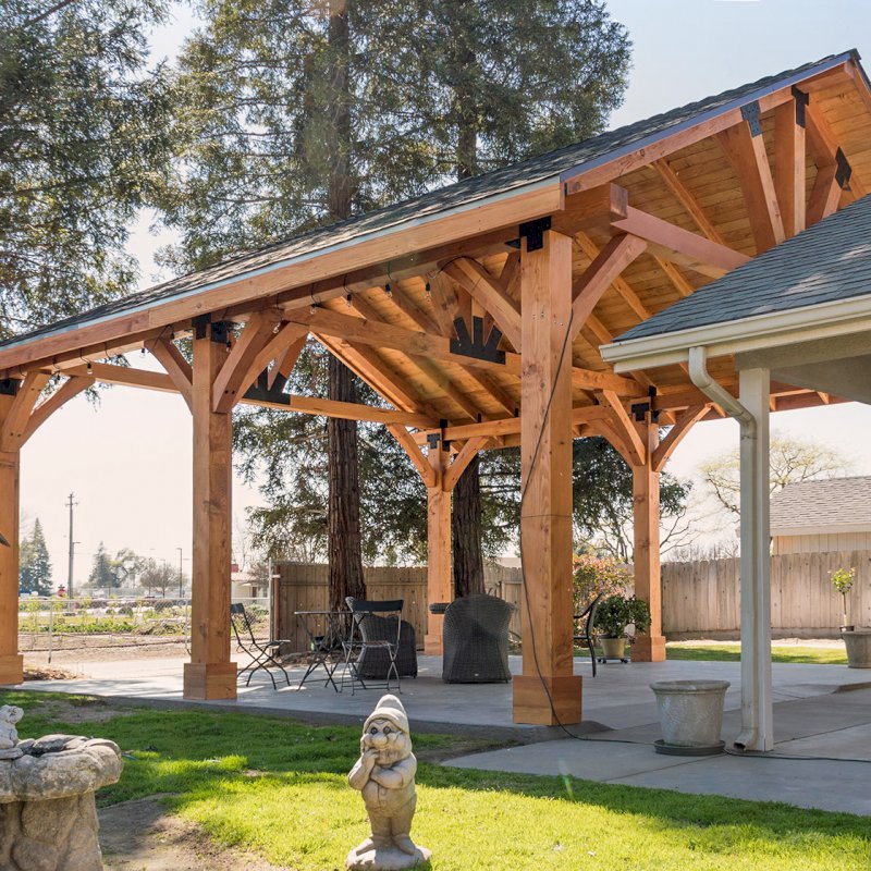 The Thick Timber Toledo Wood Pavilions (Options: 27' L x 25' W, Douglas-fir, 6-Post Anchor Kit for Gale-Wind, Electrical Wiring Trim for 2 Posts, 8 x 8 Supports and Posts, 8 x 8 Rafters, 2 Fan Bases, Transparent Premium Sealant). Photo Courtesy of T. Lane of Kingsburg, CA. The Thick Timber Toledo Wood Pavilions (Options: 27' L x 25' W, Douglas-fir, 6-Post Anchor Kit for Gale-Wind, Electrical Wiring Trim for 2 Posts, 8 x 8 Supports and Posts, 8 x 8 Rafters, 2 Fan Bases, Transparent Premium Sealant). Photo Courtesy of T. Lane of Kingsburg, CA.