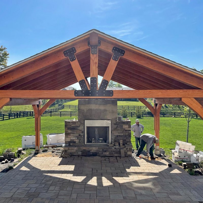 The Thick Timber Toledo Wood Pavilion (Options: 22' L x 22' W, Douglas-fir, 4-Post Anchor Kit for High-Wind, No Electrical Wiring Trim, 8 x 8 Supports and Posts, 8 x 8 Rafters, No Fan Base, Transparent Premium Sealant). Chimney Under Construction. Photo Courtesy of M. Lazhar of Ashburn, Virginia. The Thick Timber Toledo Wood Pavilion (Options: 22' L x 22' W, Douglas-fir, 4-Post Anchor Kit for High-Wind, No Electrical Wiring Trim, 8 x 8 Supports and Posts, 8 x 8 Rafters, No Fan Base, Transparent Premium Sealant). Chimney Under Construction. Photo Courtesy of M. Lazhar of Ashburn, Virginia.