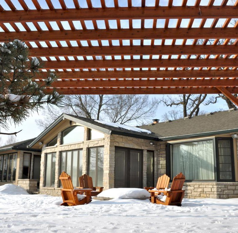 The Traditional Wooden Garden Pergola (Options: 20' L x 14' W, Mature Redwood, No Electrical Wiring Trim, Slats at 6" and Rafters at 18", Lengthwise Roof Support Timbers, 4-Post Anchor Kit for Stone, No Ceiling Fan Base, No Privacy Panels, No Curtain Rods, 9' Post Height, Transparent Premium Sealant). Photo Courtesy of Mary Louise and Gerry Neugent of Des Moines, IA. The Traditional Wooden Garden Pergola (Options: 20' L x 14' W, Mature Redwood, No Electrical Wiring Trim, Slats at 6" and Rafters at 18", Lengthwise Roof Support Timbers, 4-Post Anchor Kit for Stone, No Ceiling Fan Base, No Privacy Panels, No Curtain Rods, 9' Post Height, Transparent Premium Sealant). Photo Courtesy of Mary Louise and Gerry Neugent of Des Moines, IA.