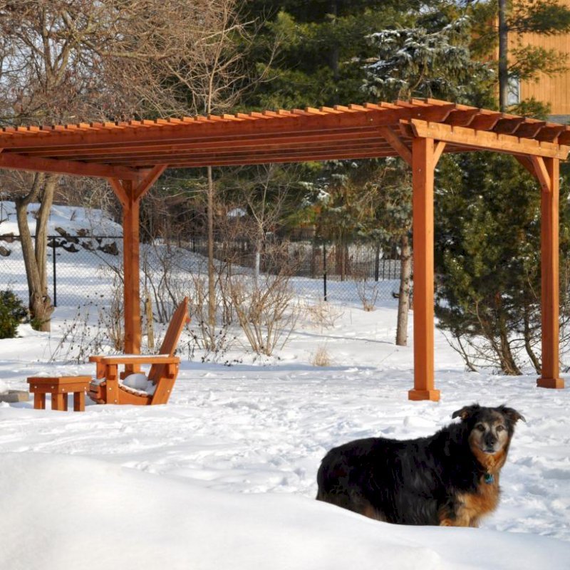 The Traditional Wooden Garden Pergola (Options: 20' L x 14' W, Mature Redwood, No Electrical Wiring Trim, Slats at 6" and Rafters at 18", Lengthwise Roof Support Timbers, 4-Post Anchor Kit for Stone, No Ceiling Fan Base, No Privacy Panels, No Curtain Rods, 9' Post Height, Transparent Premium Sealant). Photo Courtesy of Mary Louise and Gerry Neugent of Des Moines, IA. The Traditional Wooden Garden Pergola (Options: 20' L x 14' W, Mature Redwood, No Electrical Wiring Trim, Slats at 6" and Rafters at 18", Lengthwise Roof Support Timbers, 4-Post Anchor Kit for Stone, No Ceiling Fan Base, No Privacy Panels, No Curtain Rods, 9' Post Height, Transparent Premium Sealant). Photo Courtesy of Mary Louise and Gerry Neugent of Des Moines, IA.