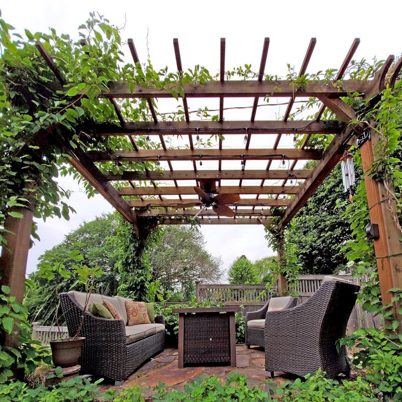 The Traditional Wooden Garden Pergola (Options: 14' L x 12' W, Mature Redwood, No Electrical Wiring Trim, Open Roof with Slats at 18", Rafters at 18", Lengthwise Roof Support Timbers, 4-Post Anchor Kit for Concrete, No Ceiling Fan Base, No Privacy Panels, No Curtain Rods, 9' Post Height, Transparent Premium Sealant). Photo Courtesy of D. Vickery of St. Paul, Minnesota. The Traditional Wooden Garden Pergola (Options: 14' L x 12' W, Mature Redwood, No Electrical Wiring Trim, Open Roof with Slats at 18", Rafters at 18", Lengthwise Roof Support Timbers, 4-Post Anchor Kit for Concrete, No Ceiling Fan Base, No Privacy Panels, No Curtain Rods, 9' Post Height, Transparent Premium Sealant). Photo Courtesy of D. Vickery of St. Paul, Minnesota.