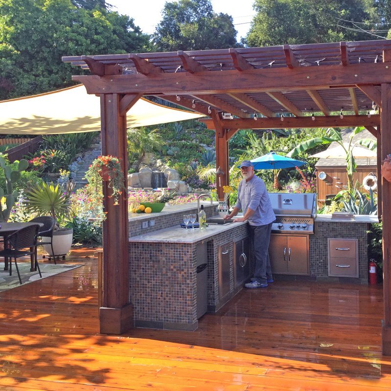 The Traditional Wooden Garden Pergola (Options: 14' L x 11' W, Mature Redwood, Electrical Wiring Trim for2 Posts, Open Roof with Slats at 6", Rafters at 18", 4-Post Anchor Kit for Wood, No Ceiling Fan Base, No Privacy Panels, Vertical Post Decorative Trims, No Curtain Rod, 9' Post Height, Transparent Premium Sealant). Photo Courtesy of J. Turner of Santa Barbara, California. The Traditional Wooden Garden Pergola (Options: 14' L x 11' W, Mature Redwood, Electrical Wiring Trim for2 Posts, Open Roof with Slats at 6", Rafters at 18", 4-Post Anchor Kit for Wood, No Ceiling Fan Base, No Privacy Panels, Vertical Post Decorative Trims, No Curtain Rod, 9' Post Height, Transparent Premium Sealant). Photo Courtesy of J. Turner of Santa Barbara, California.
