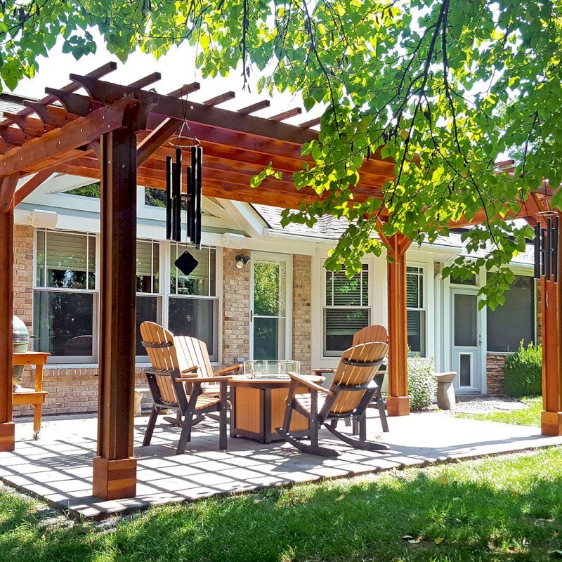 The Traditional Wooden Garden Pergola (Options: 10' L x 20' W, California Redwood, No Electrical Wiring Trim, Open Roof with Slats at 12", Rafters at 18", 4-Post Anchor Kit for Concrete, Vertical Post Decorative Trim, No Ceiling Fan Base, No Privacy Panels, No Curtain Rods, Transparent Premium Sealant). Photo Courtesy of J. Karibian of Saint Charles, Missouri. The Traditional Wooden Garden Pergola (Options: 10' L x 20' W, California Redwood, No Electrical Wiring Trim, Open Roof with Slats at 12", Rafters at 18", 4-Post Anchor Kit for Concrete, Vertical Post Decorative Trim, No Ceiling Fan Base, No Privacy Panels, No Curtain Rods, Transparent Premium Sealant). Photo Courtesy of J. Karibian of Saint Charles, Missouri.