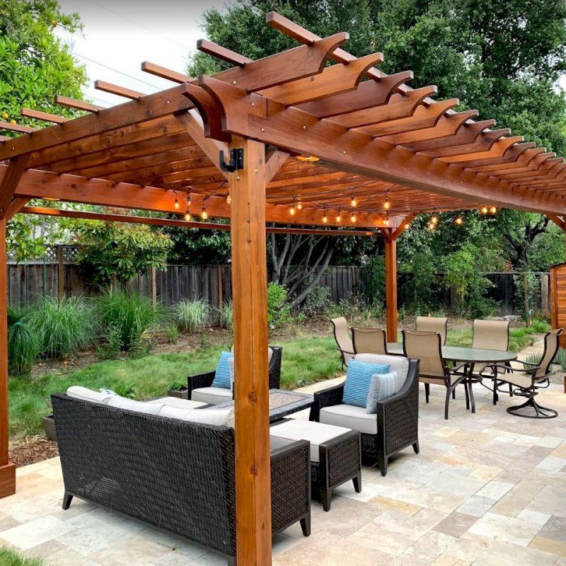 The Traditional Wooden Garden Pergola (Options: 25' L x 14' W, California Redwood, Electrical Wiring Trim for 2 Posts, Open Roof with Slats at 18", with 2' Overhang by Custom Request, Rafters at 12", 4-Post Anchor Kit for Gale-Wind, No Ceiling Fan Base, No Privacy Panels, Curtain Rods on 2 Sides, 9.5' Post Height, Transparent Premium Sealant). Photo Also Shows a Storage Shed. Photo Courtesy of J. Lewis of Mountain View, CA. The Traditional Wooden Garden Pergola (Options: 25' L x 14' W, California Redwood, Electrical Wiring Trim for 2 Posts, Open Roof with Slats at 18", with 2' Overhang by Custom Request, Rafters at 12", 4-Post Anchor Kit for Gale-Wind, No Ceiling Fan Base, No Privacy Panels, Curtain Rods on 2 Sides, 9.5' Post Height, Transparent Premium Sealant). Photo Also Shows a Storage Shed. Photo Courtesy of J. Lewis of Mountain View, CA.