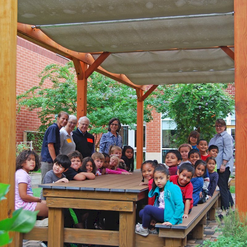 The Traditional Wooden Garden Pergola (Options: 30' L x 12' W, Douglas-fir, Open Roof with Slats at 18, Transparent Premium Sealant). Shade clothe is a wonderful way to increase shade when needed. Shade Clothe shown is a custom detail we can add for you. Photo Courtesy of Frederick Douglass Elementary School of Lessburg, Virginia. The Traditional Wooden Garden Pergola (Options: 30' L x 12' W, Douglas-fir, Open Roof with Slats at 18, Transparent Premium Sealant). Shade clothe is a wonderful way to increase shade when needed. Shade Clothe shown is a custom detail we can add for you. Photo Courtesy of Frederick Douglass Elementary School of Lessburg, Virginia.