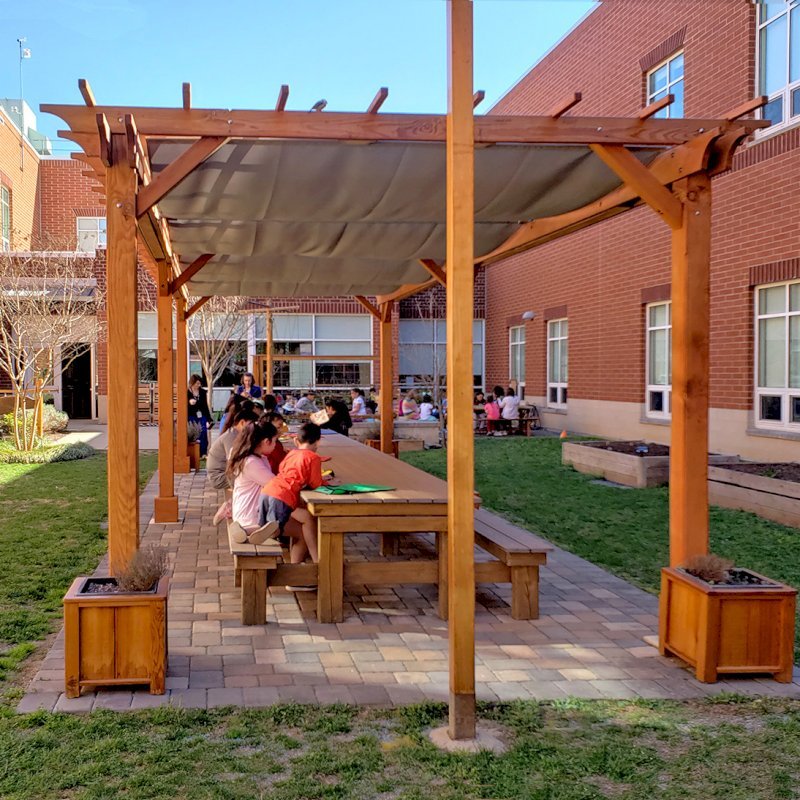 The Traditional Wooden Garden Pergola (Options: 30' L x 12' W, Douglas-fir, Open Roof with Slats at 18, Transparent Premium Sealant). Shade clothe is a wonderful way to increase shade when needed. Shade Clothe shown is a custom detail we can add for you. Photo Courtesy of Frederick Douglass Elementary School of Lessburg, Virginia. The Traditional Wooden Garden Pergola (Options: 30' L x 12' W, Douglas-fir, Open Roof with Slats at 18, Transparent Premium Sealant). Shade clothe is a wonderful way to increase shade when needed. Shade Clothe shown is a custom detail we can add for you. Photo Courtesy of Frederick Douglass Elementary School of Lessburg, Virginia.