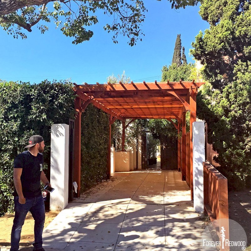 The Traditional Wooden Garden Pergola (Options: 30' L x 10' W, California Redwood, No Electrical Wiring Trim, Open Roof with Slats at 12", Rafters at 18", Lengthwise Roof Support Timbers, 4-Post Anchor Kit for Concrete, No Ceiling Fan Base, No Privacy Panels, No Curtain Rods, 9.5' Post Height, Transparent Premium Sealant). Photo Courtesy of Sunday Stevens and David Klein of Los Angeles, California. The Traditional Wooden Garden Pergola (Options: 30' L x 10' W, California Redwood, No Electrical Wiring Trim, Open Roof with Slats at 12", Rafters at 18", Lengthwise Roof Support Timbers, 4-Post Anchor Kit for Concrete, No Ceiling Fan Base, No Privacy Panels, No Curtain Rods, 9.5' Post Height, Transparent Premium Sealant). Photo Courtesy of Sunday Stevens and David Klein of Los Angeles, California.