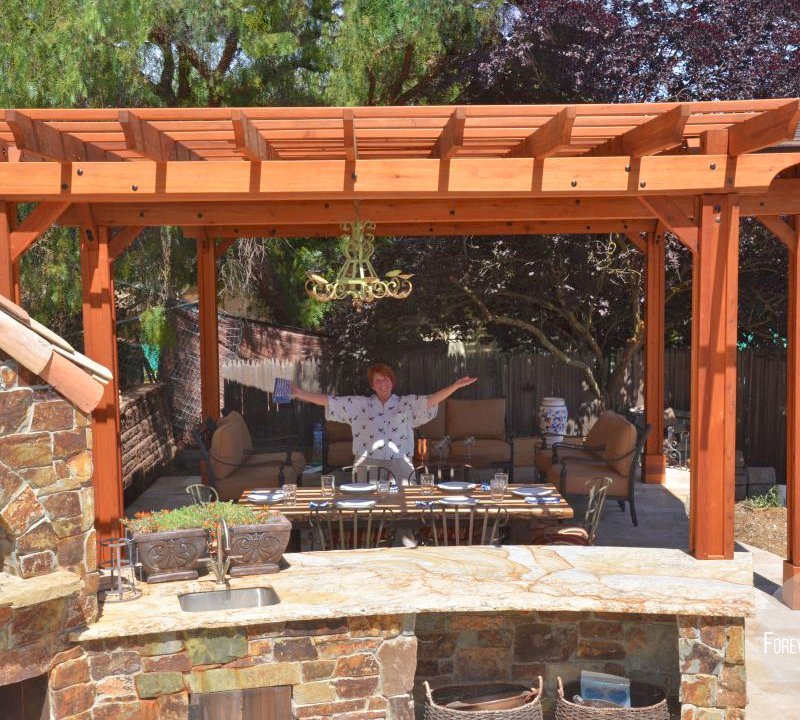 Garden Pergola Attached to a 18' x 18' Backyard Pavilion (Options: 14' L x 9' W, Mature Redwood, Electrical Wiring Trim for 1 Post, Open Roof with Slats at 18", Rafters at 18", Lengthwise Roof Support Timbers, 6 Post Anchor Kit for Gale-Wind, 2 Ceiling Fan Base, No Privacy Panels, No Curtain Rods, 10' Post Height, Transparent Premium Sealant). Photo Courtesy of J. Angwin of Morgan Hill, CA. Garden Pergola Attached to a 18' x 18' Backyard Pavilion (Options: 14' L x 9' W, Mature Redwood, Electrical Wiring Trim for 1 Post, Open Roof with Slats at 18", Rafters at 18", Lengthwise Roof Support Timbers, 6 Post Anchor Kit for Gale-Wind, 2 Ceiling Fan Base, No Privacy Panels, No Curtain Rods, 10' Post Height, Transparent Premium Sealant). Photo Courtesy of J. Angwin of Morgan Hill, CA.