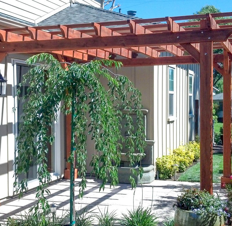 The Traditional Wooden Garden Pergola (Options: 12' L x 12' W, Mature Redwood, Electrical Wiring Trim for 1 Post, Open Roof with Slats at 18", Rafters at 18", 4-post kit for Stone, Brick, or Concrete, No Ceilin Fan Base, No Privacy Panels, No Curtain Rods, 8.5' Post Height, Transparent Premium Sealant). The Traditional Wooden Garden Pergola (Options: 12' L x 12' W, Mature Redwood, Electrical Wiring Trim for 1 Post, Open Roof with Slats at 18", Rafters at 18", 4-post kit for Stone, Brick, or Concrete, No Ceilin Fan Base, No Privacy Panels, No Curtain Rods, 8.5' Post Height, Transparent Premium Sealant).