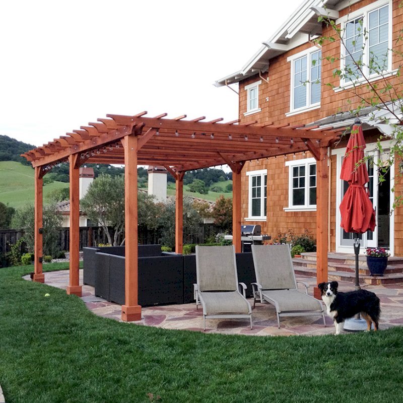 The Traditional Wooden Garden Pergola (Options: 22' L x 14' W, Mature Redwood, Electrical Wiring Trim for 2 Posts, Open Roof with Slats at 6", Rafters at 18", Widthwise Roof Support Timbers, 6-Post Anchor Kit for Concrete, No Ceiling Fan Base, No Privacy Panels, No Curtain Rods, 9.5' Post Height, Transparent Premium Sealant). Photo Courtesy of Roger Cassidy of Novato, CA. The Traditional Wooden Garden Pergola (Options: 22' L x 14' W, Mature Redwood, Electrical Wiring Trim for 2 Posts, Open Roof with Slats at 6", Rafters at 18", Widthwise Roof Support Timbers, 6-Post Anchor Kit for Concrete, No Ceiling Fan Base, No Privacy Panels, No Curtain Rods, 9.5' Post Height, Transparent Premium Sealant). Photo Courtesy of Roger Cassidy of Novato, CA.