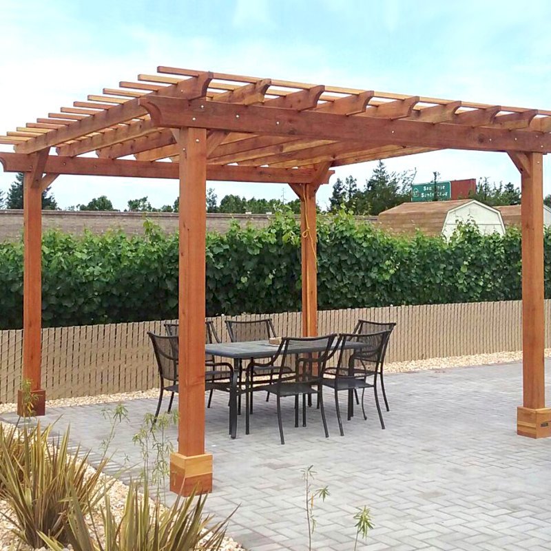The Traditional Wooden Garden Pergola (Options: 14' L x 14' W, California Redwood, Electrical Wiring Trim for 1 Post, Open Roof with Slats at 12", Rafters at 18", 4-Post Anchor Kit for Concrete, No Ceiling Fan Base, No Privacy Panels, No Curtain Rods, Transparent Premium Sealant). Photo Courtesy of J. Welsh of Los Gatos, CA. The Traditional Wooden Garden Pergola (Options: 14' L x 14' W, California Redwood, Electrical Wiring Trim for 1 Post, Open Roof with Slats at 12", Rafters at 18", 4-Post Anchor Kit for Concrete, No Ceiling Fan Base, No Privacy Panels, No Curtain Rods, Transparent Premium Sealant). Photo Courtesy of J. Welsh of Los Gatos, CA.