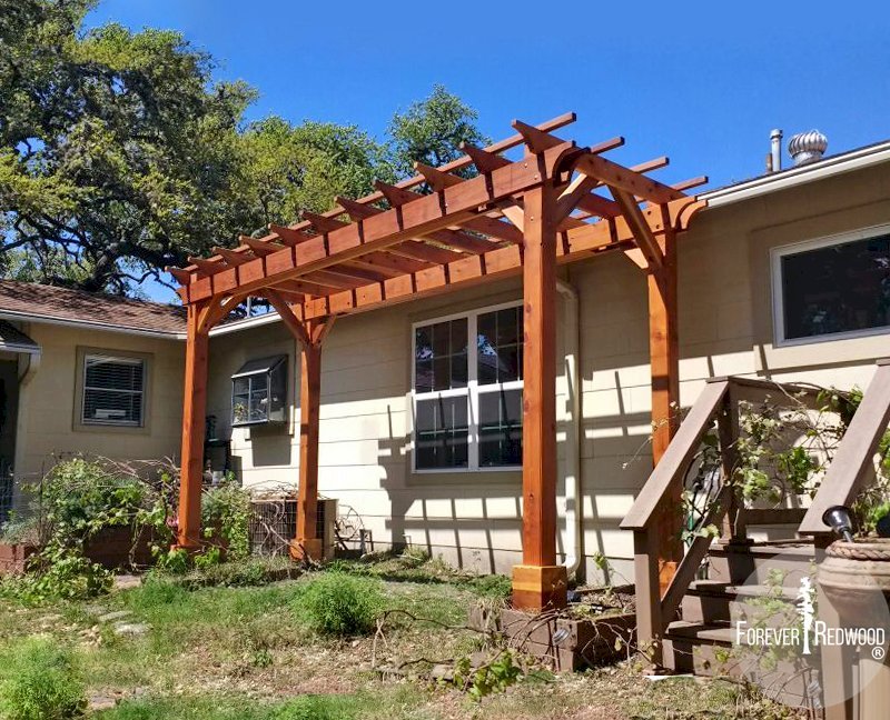 The Traditional Wooden Garden Pergola (Options: 6' L x 16' W, California Redwood, No Electrical Wiring Trim, Open Roof with Slats at 18", Rafters at 18", 4-Post Anchor Kit, No Ceiling Fan Base, No Privacy Panels, No Curtain Rods, 9' Post Height, Transparent Premium Sealant). Photo Courtesy of L. Manning of Boeme, TX. The Traditional Wooden Garden Pergola (Options: 6' L x 16' W, California Redwood, No Electrical Wiring Trim, Open Roof with Slats at 18", Rafters at 18", 4-Post Anchor Kit, No Ceiling Fan Base, No Privacy Panels, No Curtain Rods, 9' Post Height, Transparent Premium Sealant). Photo Courtesy of L. Manning of Boeme, TX.
