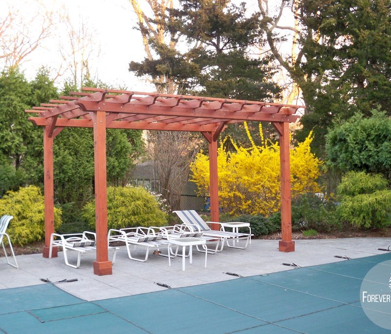 The Traditional Wooden Garden Pergola (Options: 16' L x 10' W, Mature Redwood, No Electrical Wiring Trim, Open Roof with Slats at 6", Rafters at 18", Lengthwise Roof Support Timbers, 4-Post Anchor Kit for Stone, No Ceiling Fan Base, No Privacy Panels, No Curtain Rods, 9' Post Height, Transparent Premium Sealant). The Traditional Wooden Garden Pergola (Options: 16' L x 10' W, Mature Redwood, No Electrical Wiring Trim, Open Roof with Slats at 6", Rafters at 18", Lengthwise Roof Support Timbers, 4-Post Anchor Kit for Stone, No Ceiling Fan Base, No Privacy Panels, No Curtain Rods, 9' Post Height, Transparent Premium Sealant).
