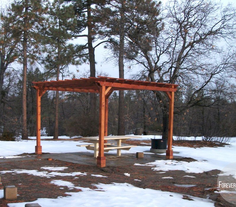 The Traditional Wooden Garden Pergola (Options: 15' L x 15' W, Mature Redwood, No Electrical Wiring Trim, Open Roof with Slats at 18", Rafters at 18", 4-Post Anchor Kit for Stone, No Ceiling Fan Base, No Privacy Panels, No Curtain Rods, 9' Post Height, Transparent Premium Sealant). 1 of 9 Pergolas installed in the Cleveland National Forest's Burnt Rancheria Campground,1 hr west of San Diego. The Traditional Wooden Garden Pergola (Options: 15' L x 15' W, Mature Redwood, No Electrical Wiring Trim, Open Roof with Slats at 18", Rafters at 18", 4-Post Anchor Kit for Stone, No Ceiling Fan Base, No Privacy Panels, No Curtain Rods, 9' Post Height, Transparent Premium Sealant). 1 of 9 Pergolas installed in the Cleveland National Forest's Burnt Rancheria Campground,1 hr west of San Diego.