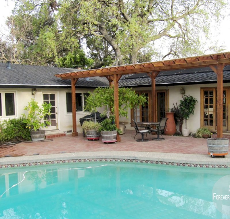 The Traditional Wooden Garden Pergola (Options: 32' L x 14' W, Mature Redwood, No Electrical Wiring Trim, Slats at 12", Rafters at 18", Lengthwise Roof Support Timbers, 6-Post Anchor Kit for Stone, No Ceiling Fan Base, No Privacy Panels, No Curtain Rods, 9' Post Height, Transparent Premium Sealant). Slight Incline by Custom Request, If you'd like a "waterproof pergola" we can help with a slight incline in the roof design. The Traditional Wooden Garden Pergola (Options: 32' L x 14' W, Mature Redwood, No Electrical Wiring Trim, Slats at 12", Rafters at 18", Lengthwise Roof Support Timbers, 6-Post Anchor Kit for Stone, No Ceiling Fan Base, No Privacy Panels, No Curtain Rods, 9' Post Height, Transparent Premium Sealant). Slight Incline by Custom Request, If you'd like a "waterproof pergola" we can help with a slight incline in the roof design.