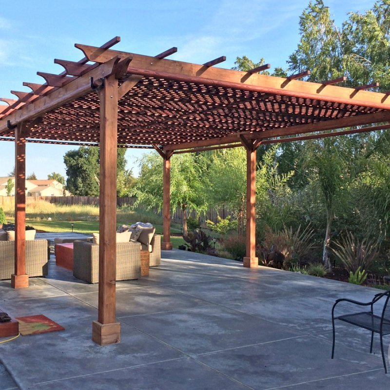 The Traditional Wooden Garden Pergola (Options: 25' L x 18' W, California Redwood, No Electrical Wiring Trim, Lattice Roof, Lengthwise Roof Support Timbers, 6-Post Anchor Kit for Stone, No ceiling Fan Base, No Privacy Panels, 4 Curtains Rods, 9.5' Post Height, Transparent Premium Sealant). Photo Courtesy of Tom Deckowski of Morgan Hill, CA. Note that photo shows 2 yr old finish that is partially faded. The Traditional Wooden Garden Pergola (Options: 25' L x 18' W, California Redwood, No Electrical Wiring Trim, Lattice Roof, Lengthwise Roof Support Timbers, 6-Post Anchor Kit for Stone, No ceiling Fan Base, No Privacy Panels, 4 Curtains Rods, 9.5' Post Height, Transparent Premium Sealant). Photo Courtesy of Tom Deckowski of Morgan Hill, CA. Note that photo shows 2 yr old finish that is partially faded.