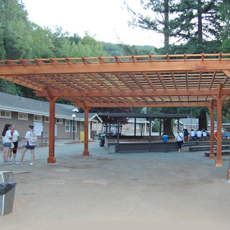 The Traditional Wooden Garden Pergola (Options: 30' L x 30' W, California Redwood, No Electrical Wiring Trim, Open Roof with Slats at 18", Rafters at 18", 6-Post Anchor Kit for Gale-Wind, No Ceiling Fan Base, No Privacy Panels, No Curtain Rods, 10' Post Height, Transparent Premium Sealant). Before the tables and pavers were added. Photo Courtesy of Via West Campground located at 13851 Stevens Canyon Rd, Cupertino, CA. The Traditional Wooden Garden Pergola (Options: 30' L x 30' W, California Redwood, No Electrical Wiring Trim, Open Roof with Slats at 18", Rafters at 18", 6-Post Anchor Kit for Gale-Wind, No Ceiling Fan Base, No Privacy Panels, No Curtain Rods, 10' Post Height, Transparent Premium Sealant). Before the tables and pavers were added. Photo Courtesy of Via West Campground located at 13851 Stevens Canyon Rd, Cupertino, CA.