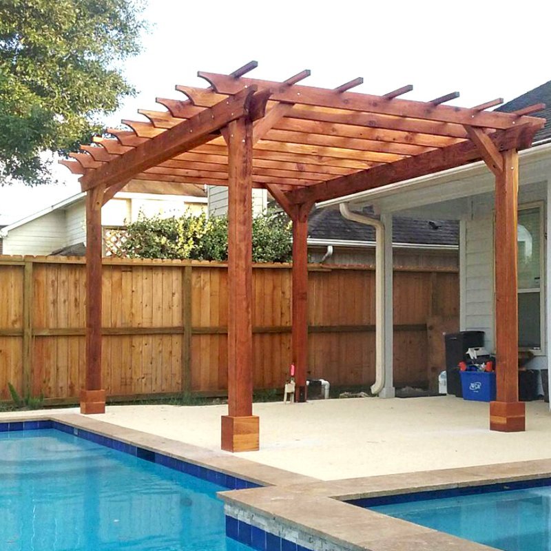 The Traditional Wooden Garden Pergola (Options: 15' L x 11' W, California Redwood, No Electrical Wiring Trims, Open Roof with Slats at 18", Rafters at 18", 4-Post Anchor Kit for Concrete, No Ceiling Fan Base, No Privacy Panels, No Curtain Rods, Transparent Premium Sealant). Photo Courtesy of T. Mullin of Katy, TX. The Traditional Wooden Garden Pergola (Options: 15' L x 11' W, California Redwood, No Electrical Wiring Trims, Open Roof with Slats at 18", Rafters at 18", 4-Post Anchor Kit for Concrete, No Ceiling Fan Base, No Privacy Panels, No Curtain Rods, Transparent Premium Sealant). Photo Courtesy of T. Mullin of Katy, TX.