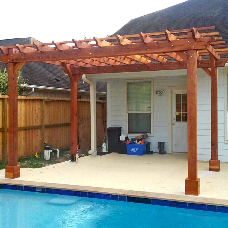 The Traditional Wooden Garden Pergola (Options: 15' L x 11' W, California Redwood, No Electrical Wiring Trims, Open Roof with Slats at 18", Rafters at 18", 4-Post Anchor Kit for Concrete, No Ceiling Fan Base, No Privacy Panels, No Curtain Rods, Transparent Premium Sealant). Photo Courtesy of T. Mullin of Katy, TX. The Traditional Wooden Garden Pergola (Options: 15' L x 11' W, California Redwood, No Electrical Wiring Trims, Open Roof with Slats at 18", Rafters at 18", 4-Post Anchor Kit for Concrete, No Ceiling Fan Base, No Privacy Panels, No Curtain Rods, Transparent Premium Sealant). Photo Courtesy of T. Mullin of Katy, TX.