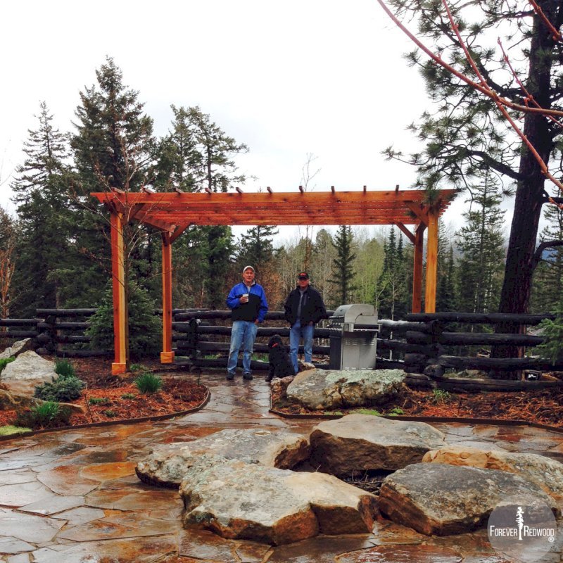 The Traditional Wooden Garden Pergola (Options: 12' L x 18' W, California Redwood, No Electrical Wiring Trim, Open Roof with Slats at 18", Rafters at 18", Widthwise Roof Support Timbers, 4-Post Anchor Kit for Concrete, No Ceiling Fan Base, No Privacy Panels, No Curtain Rods, 9' Post Height, Transparent Premium Sealant). Photo Courtesy of Tim M. of Durango, CO. The Traditional Wooden Garden Pergola (Options: 12' L x 18' W, California Redwood, No Electrical Wiring Trim, Open Roof with Slats at 18", Rafters at 18", Widthwise Roof Support Timbers, 4-Post Anchor Kit for Concrete, No Ceiling Fan Base, No Privacy Panels, No Curtain Rods, 9' Post Height, Transparent Premium Sealant). Photo Courtesy of Tim M. of Durango, CO.