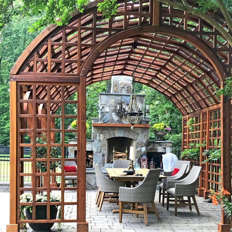 The Victorian Trellis (Options: 22' L x 14' W, Combination of Arcs and Lattice Panels, Mature Redwood, No Rain Guard, 9' Post Height, No Electrical Wiring Trim, 4-Post Anchor Kit for Stone, No Ceiling Fan Base, Transparent Premium Sealant). Photo Courtesy of JR and Trish West of King George, Virginia. The Victorian Trellis (Options: 22' L x 14' W, Combination of Arcs and Lattice Panels, Mature Redwood, No Rain Guard, 9' Post Height, No Electrical Wiring Trim, 4-Post Anchor Kit for Stone, No Ceiling Fan Base, Transparent Premium Sealant). Photo Courtesy of JR and Trish West of King George, Virginia.