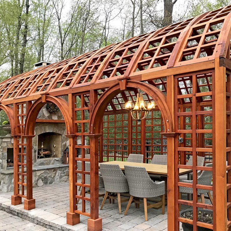 The Victorian Trellis (Options: 22' L x 14' W, Combination of Arcs and Lattice Panels, Mature Redwood, No Rain Guard, 9' Post Height, No Electrical Wiring Trim, 4-Post Anchor Kit for Stone, No Ceiling Fan Base, Transparent Premium Sealant). Photo Courtesy of JR and Trish West of King George, Virginia. The Victorian Trellis (Options: 22' L x 14' W, Combination of Arcs and Lattice Panels, Mature Redwood, No Rain Guard, 9' Post Height, No Electrical Wiring Trim, 4-Post Anchor Kit for Stone, No Ceiling Fan Base, Transparent Premium Sealant). Photo Courtesy of JR and Trish West of King George, Virginia.