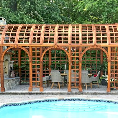 The Victorian Trellis (Options: 22' L x 14' W, Combination of Arcs and Lattice Panels, Mature Redwood, No Rain Guard, 9' Post Height, No Electrical Wiring Trim, Post Anchor Kit for Stone, No Ceiling Fan Base, Transparent Premium Sealant). Photo Courtesy of JR and Trish West of King George, Virginia.