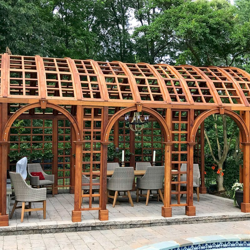 The Victorian Trellis (Options: 22' L x 14' W, Combination of Arcs and Lattice Panels, Mature Redwood, No Rain Guard, 9' Post Height, No Electrical Wiring Trim, 4-Post Anchor Kit for Stone, No Ceiling Fan Base, Transparent Premium Sealant). Photo Courtesy of JR and Trish West of King George, Virginia. The Victorian Trellis (Options: 22' L x 14' W, Combination of Arcs and Lattice Panels, Mature Redwood, No Rain Guard, 9' Post Height, No Electrical Wiring Trim, 4-Post Anchor Kit for Stone, No Ceiling Fan Base, Transparent Premium Sealant). Photo Courtesy of JR and Trish West of King George, Virginia.
