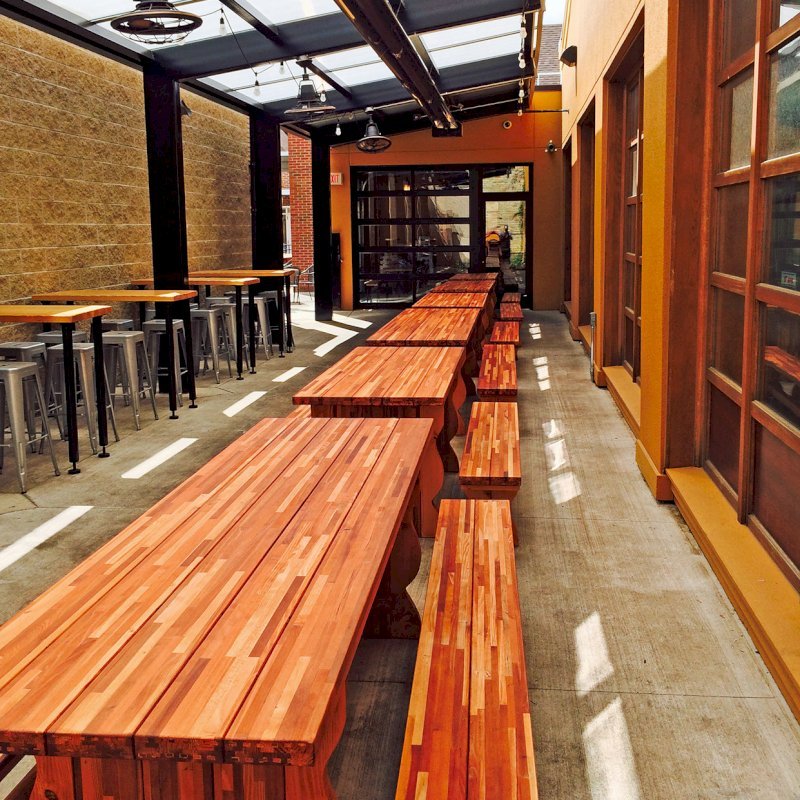 Trestle Natural Wood Outdoor Table (Options: 8' L, 34 1/2'' W Tabletop, Side Benches, Mosaic Eco-Wood, Standard Tabletop, Slightly Rounded Corners, 1 Full Length Side Benche Per Side, No Umbrella Hole, Transparent Premium Sealant). Photo Courtesy of Jason Spaulding of Grand Rapids, Michigan. Trestle Natural Wood Outdoor Table (Options: 8' L, 34 1/2'' W Tabletop, Side Benches, Mosaic Eco-Wood, Standard Tabletop, Slightly Rounded Corners, 1 Full Length Side Benche Per Side, No Umbrella Hole, Transparent Premium Sealant). Photo Courtesy of Jason Spaulding of Grand Rapids, Michigan.