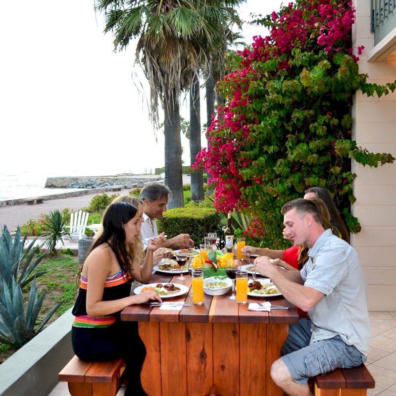 Trestle Natural Wood Outdoor Table (Options: 6' L, 34 1/2" W Tabletop, Side Benches, Redwood, 2 Half Lenght Benches/Side, Standard Tabletop, Squared Corners, No Umbrella Hole, Transparent Premium Sealant). Photo Courtesy of The Estero Beach Resort, Ensenada, Mexico Trestle Natural Wood Outdoor Table (Options: 6' L, 34 1/2" W Tabletop, Side Benches, Redwood, 2 Half Lenght Benches/Side, Standard Tabletop, Squared Corners, No Umbrella Hole, Transparent Premium Sealant). Photo Courtesy of The Estero Beach Resort, Ensenada, Mexico