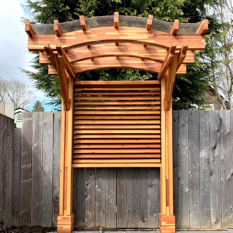 Two-Post Arched Wood Arbor (Options: 6' x 3', Mosaic Eco-Wood, 7' Posts Height, Add Oversize Arbor Kit, Custom Louvered Half Height Privacy Wall Added by Customer Request, Vertical Post Decorative Trims, with Rain Guard, Transparent Premium Sealant). Photo Courtesy of E. Baechler of Portland, Oregon. Two-Post Arched Wood Arbor (Options: 6' x 3', Mosaic Eco-Wood, 7' Posts Height, Add Oversize Arbor Kit, Custom Louvered Half Height Privacy Wall Added by Customer Request, Vertical Post Decorative Trims, with Rain Guard, Transparent Premium Sealant). Photo Courtesy of E. Baechler of Portland, Oregon.