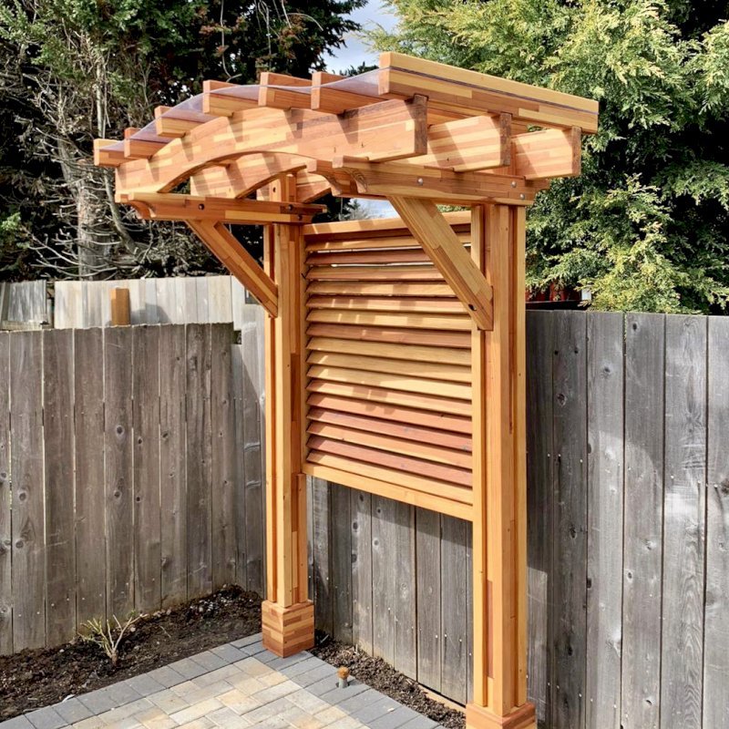 Two-Post Arched Wood Arbor (Options: 6' x 3', Mosaic Eco-Wood, 7' Posts Height, Add Oversize Arbor Kit, Custom Louvered Half Height Privacy Wall Added by Customer Request, Vertical Post Decorative Trims, with Rain Guard, Transparent Premium Sealant). Photo Courtesy of E. Baechler of Portland, Oregon. Two-Post Arched Wood Arbor (Options: 6' x 3', Mosaic Eco-Wood, 7' Posts Height, Add Oversize Arbor Kit, Custom Louvered Half Height Privacy Wall Added by Customer Request, Vertical Post Decorative Trims, with Rain Guard, Transparent Premium Sealant). Photo Courtesy of E. Baechler of Portland, Oregon.