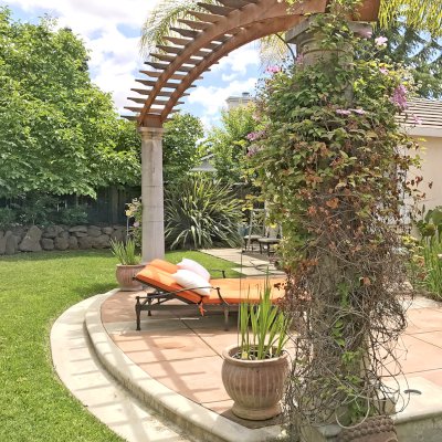 Custom Two-Post Arched Wood Arbor (Options: 22'-10" x 3', California Redwood, No Posts, Attached to Load Bearing Columns, No Privacy Panels, Transparent Premium Sealant). Photo Courtesy of Uli Rankers of Livermore, California.