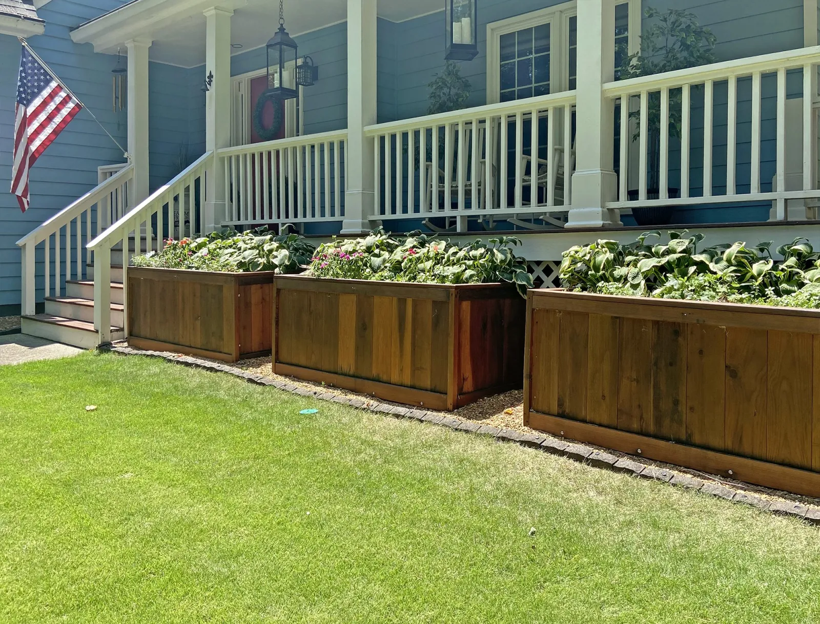 Row of redwood planters by a porch