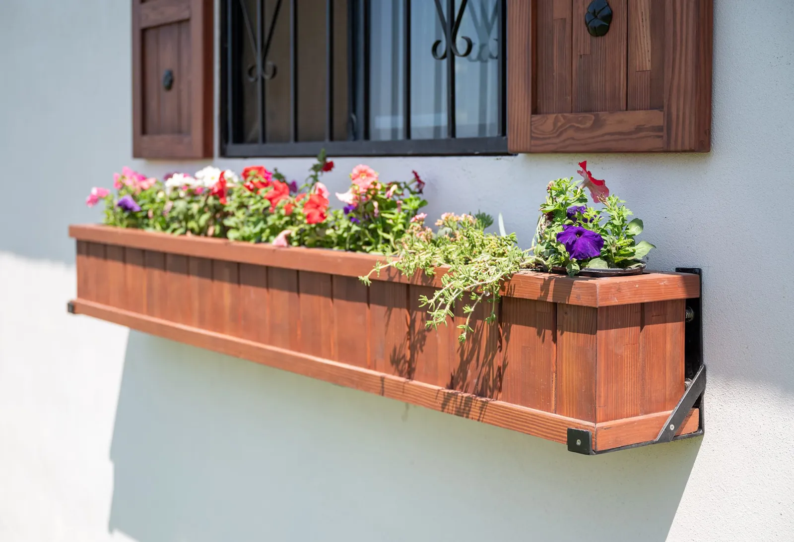 Redwood window box planter full of flowers