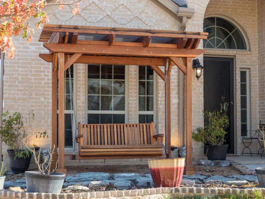 Angel's Trellis Swing (Options: 9' x 6', California Redwood, with Rain Guard, Classic Design Seat, 7.5' Posts by Custom Request, Post Anchoring for Concrete, Transparent Premium Sealant). Photo Courtesy of C. Edwards of Fort Worth, TX.