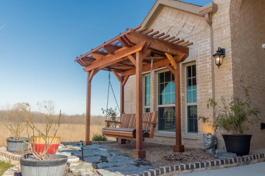 Angel's Trellis Swing (Options: 9' x 6', California Redwood, with Rain Guard, Classic Design Seat, 7.5' Posts by Custom Request, Post Anchoring for Concrete, Transparent Premium Sealant). Photo Courtesy of C. Edwards of Fort Worth, TX.