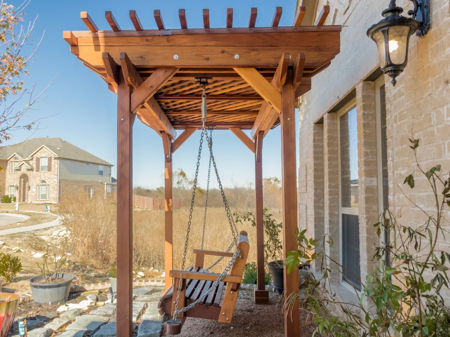Angel's Trellis Swing (Options: 9' x 6', California Redwood, with Rain Guard, Classic Design Seat, 7.5' Posts by Custom Request, Post Anchoring for Concrete, Transparent Premium Sealant). Photo Courtesy of C. Edwards of Fort Worth, TX.